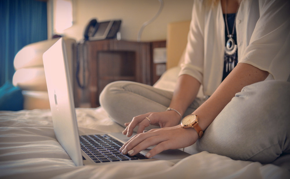 Woman using laptop in hotel